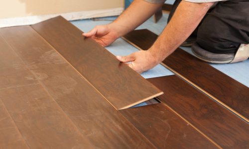 Man Installing New Laminate Wood Flooring